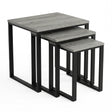 [Grey Wooden] Stackora set of 3 nesting tables angled view in a living room with sofa and accessories on grey tops
