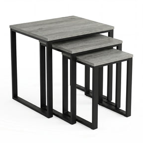 [Grey Wooden] Stackora set of 3 nesting tables angled view in a living room with sofa and accessories on grey tops