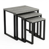 [Grey Wooden] Stackora set of 3 nesting tables angled view in a living room with sofa and accessories on grey tops