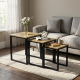 [Oak] Stackora set of 3 nesting tables in a living room beside a sofa with vase and books on oak top