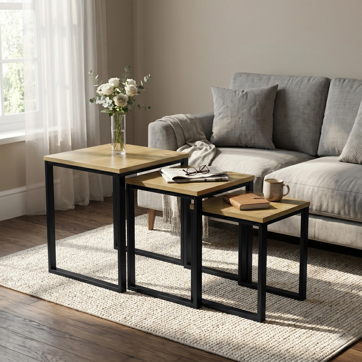 [Oak] Stackora set of 3 nesting tables in a living room beside a sofa with vase and books on oak top