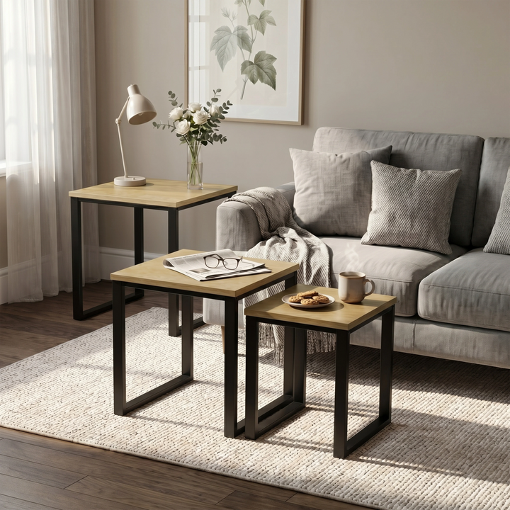 [Oak] Stackora nesting tables separated in a living room beside sofa with vase and plant on oak effect tops