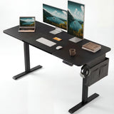 Black Electric Standing Desk with dual monitors, laptop, and accessories. Adjustable height ideal for gaming or office setup with side storage pocket.