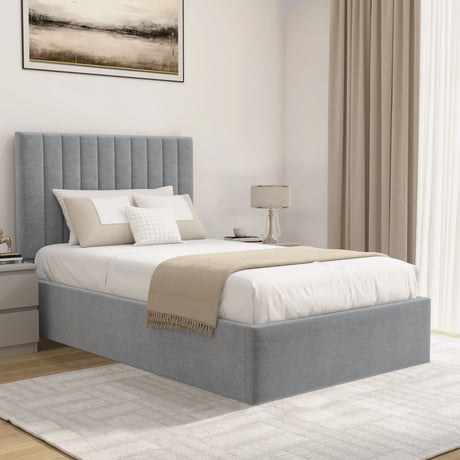 Grey upholstered bed in a bedroom setting with neutral decor