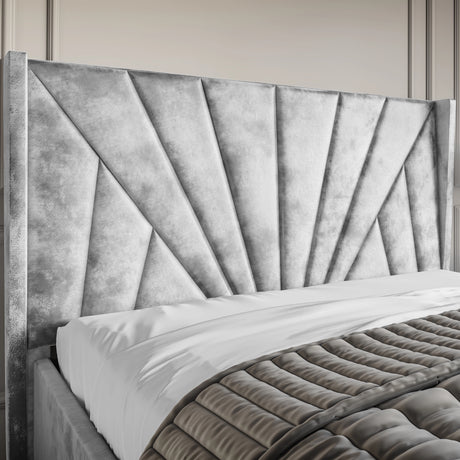 Crushed Velvet Ottoman Storage Bed Silver with Sunrise Bed Frame featuring a tall, panelled headboard in a radiant sunburst design.