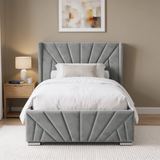 [Single | Grey] upholstered bed frame with a tall, sunrise design headboard and matching footboard, shown with white bedding in a styled bedroom setting.