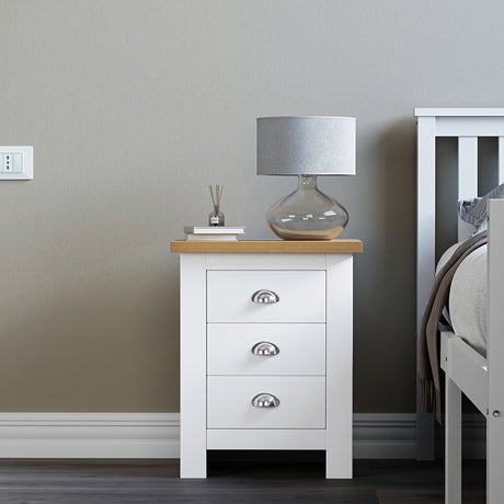 White tall bedside table with drawers and handles, ideal for storage and easy access.
