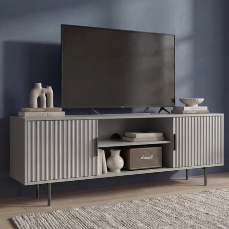 Tall grey TV entertainment stand with vertical fluted panels and slim silver legs for a modern, elevated home look.