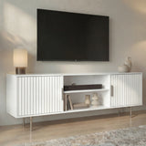 Tall white TV entertainment unit with vertical fluted panels and slim metal legs for an elegant living room look.