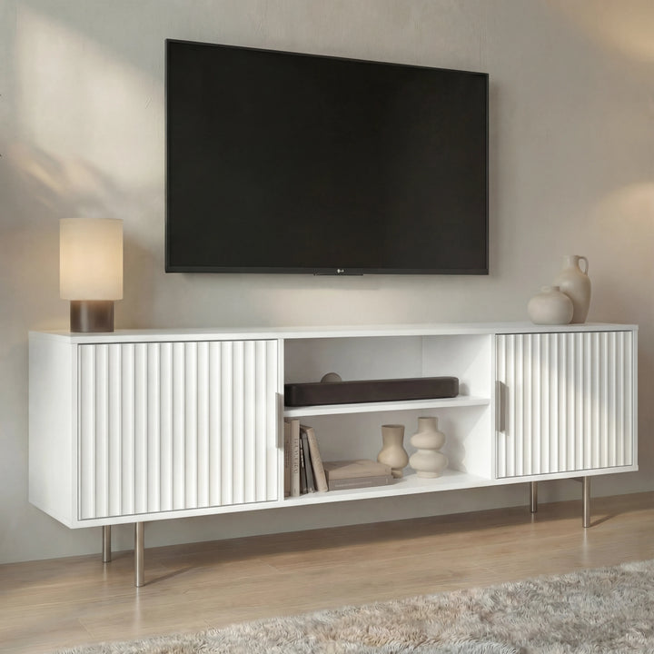 [White]  White Flutrina 140cm TV unit lifestyle, ribbed doors flank centre shelf with vase and books, table lamp on left