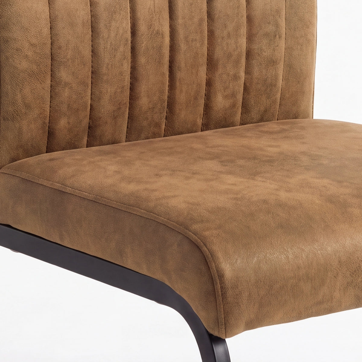 [Tan] Close-up view of suede-effect padded seat, piped edge, channelled back and black support frame.