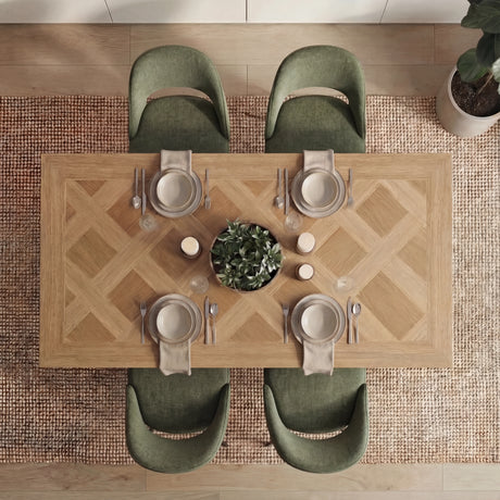 Overhead view of Aldridge dining table with 4 green chairs, styled with plates and cutlery for a modern dining experience.
