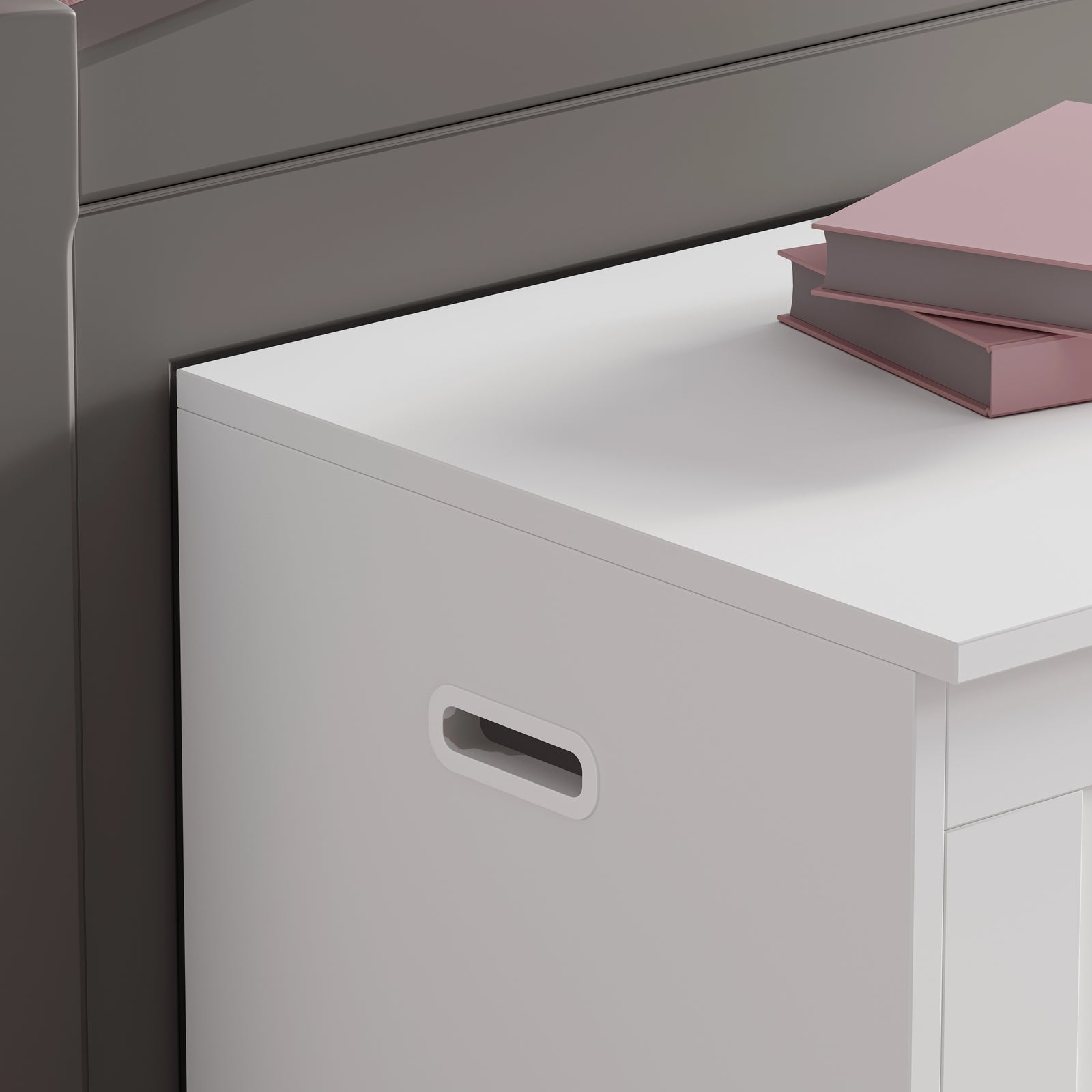 [White] Detail shot of white shaker storage chest cutout handle and lid edge against a grey wall background