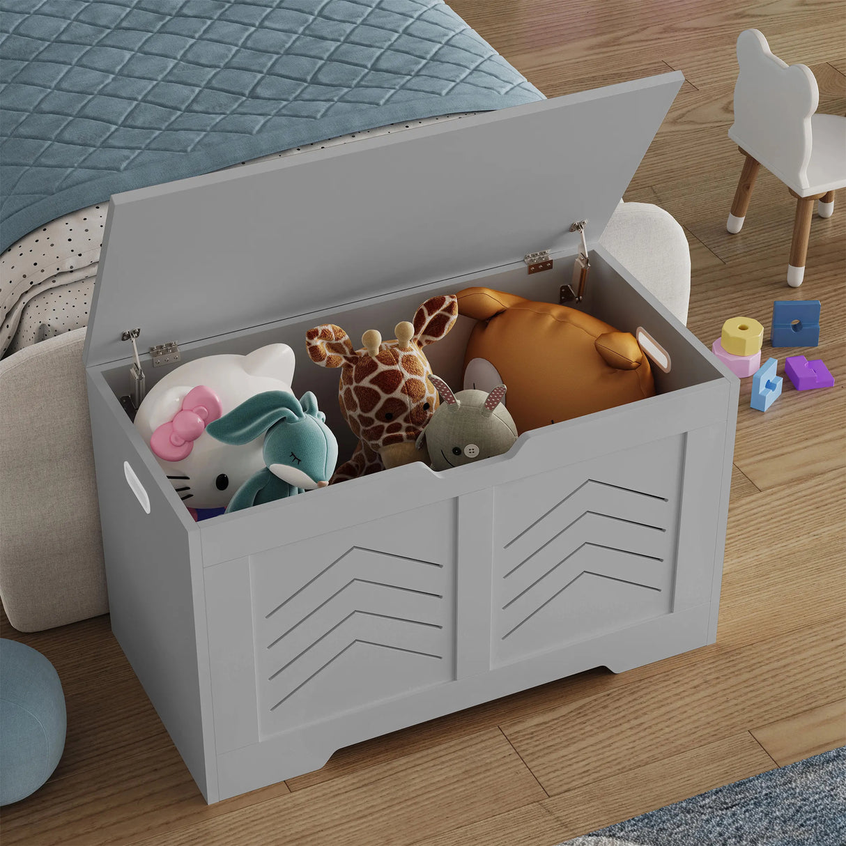 Gray toy storage box filled with stuffed animals on a wooden floor.