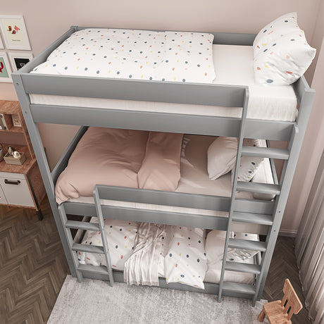 Grey triple bunk bed with top-side surface, cushions, and stairs down for easy access and comfort.