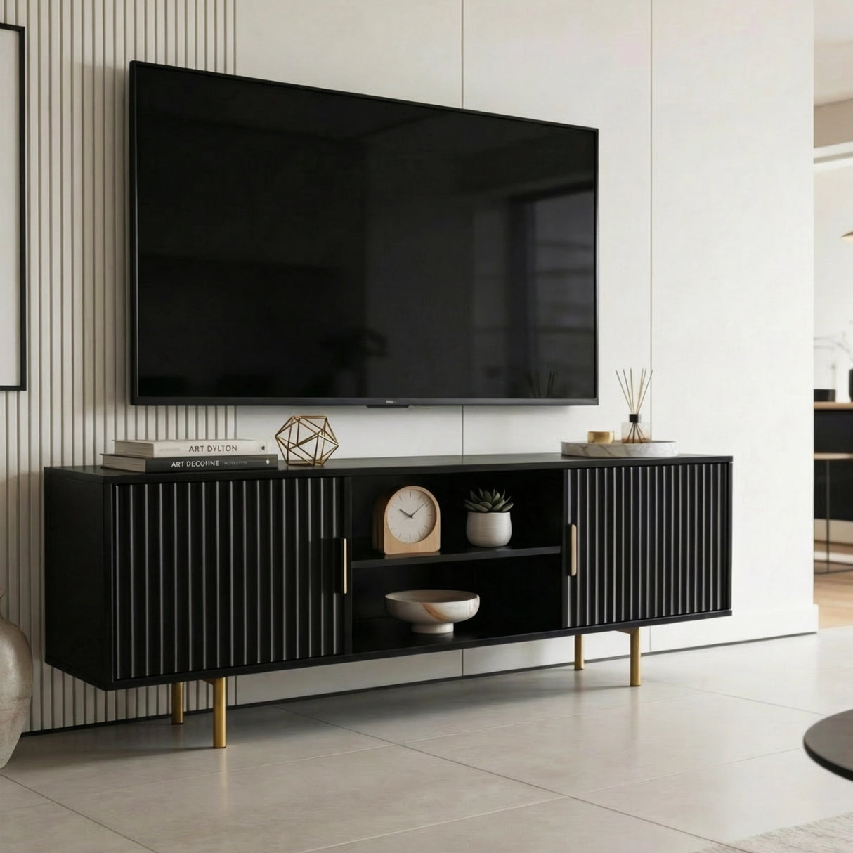 Modern black TV stand with textured fluted doors and golden legs, creating a bold focal point for contemporary lounges.