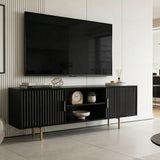 Modern black TV stand with textured fluted doors and golden legs, creating a bold focal point for contemporary lounges.