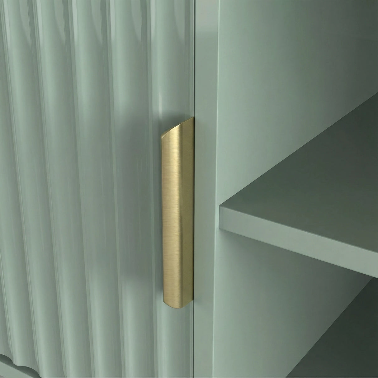 Front view of a sage green TV stand with vertical fluted doors, open shelves, and golden handle for modern media storage.