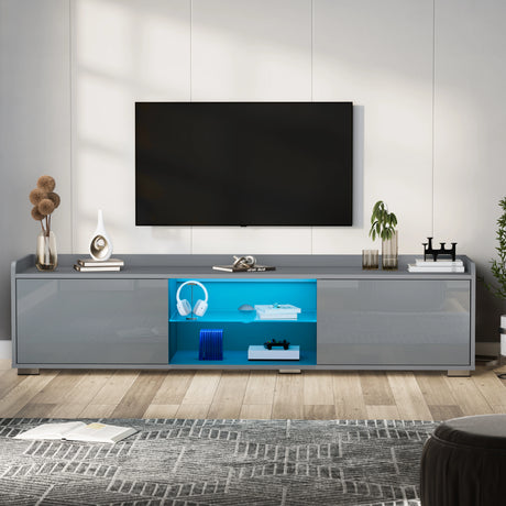 Gray TV stand with a television mounted on a white wall, featuring decorative items.