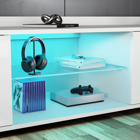 Modern entertainment console with shelves displaying headphones, books, and a gaming controller.