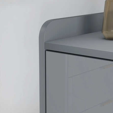 Gray side table with a curved design against a white wall