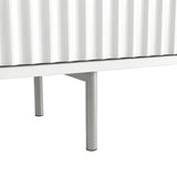 Elevated white TV unit with slim silver metal legs and textured fluted doors for a modern, airy interior design.