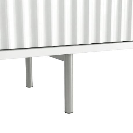 Elevated white TV unit with slim silver metal legs and textured fluted doors for a modern, airy interior design.