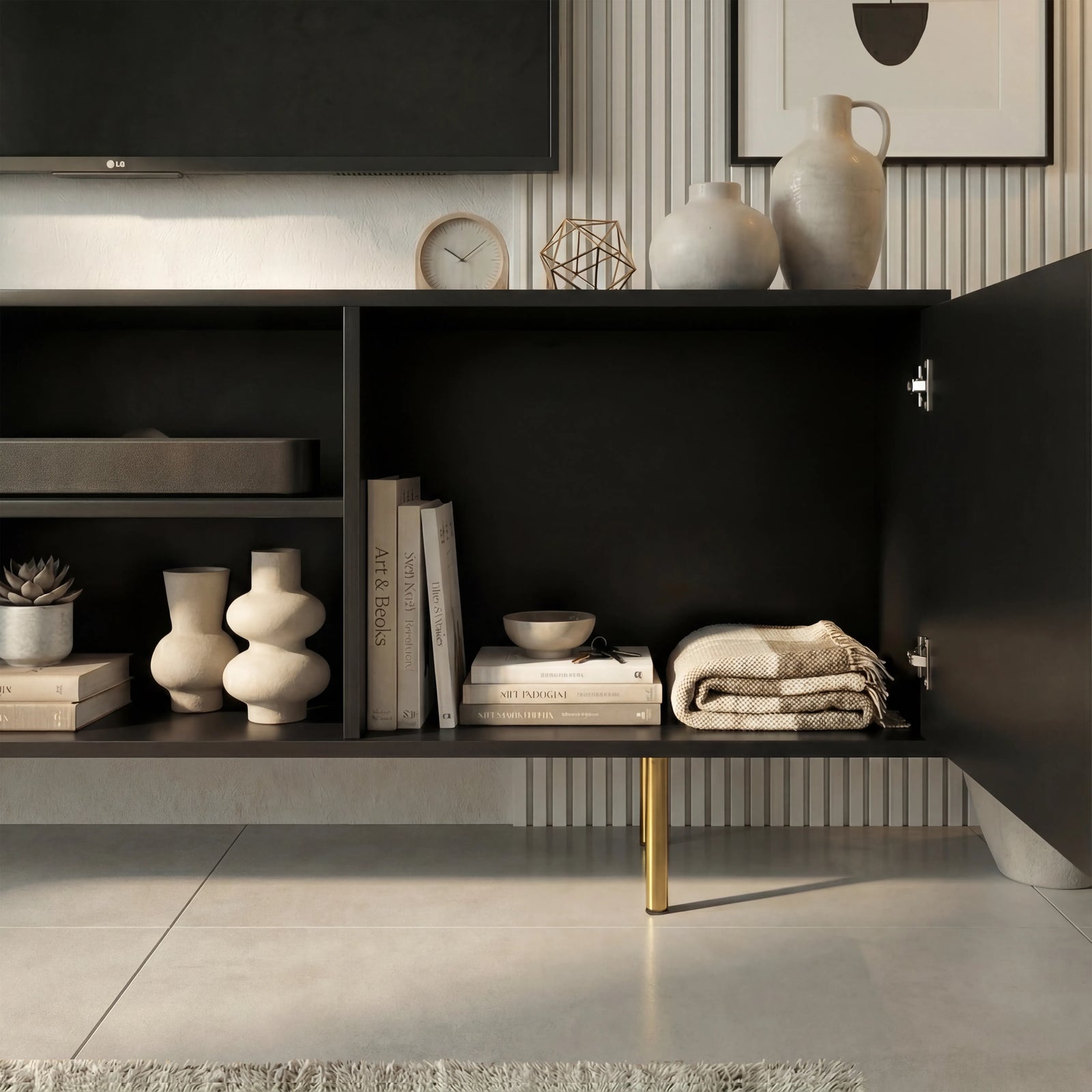 [Black]  Interior of black Flutrina TV unit with both ribbed doors open showing books, ceramic vases and folded textiles