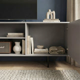 Grey TV storage unit showing internal shelves and fluted doors, designed for organized media and home accessories.