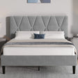 Grey upholstered bed with tufted headboard in a bedroom setting