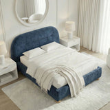 A top corner view of king size blue upholstered bed frame in a well-lit bedroom setting