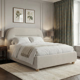 Side view of beige upholstered double bed frame with curved edges and a soft headboard