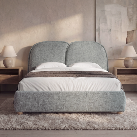 [Double | Grey] Upholstered bed frame with a soft padded headboard and wooden legs in a natural light bedroom setting