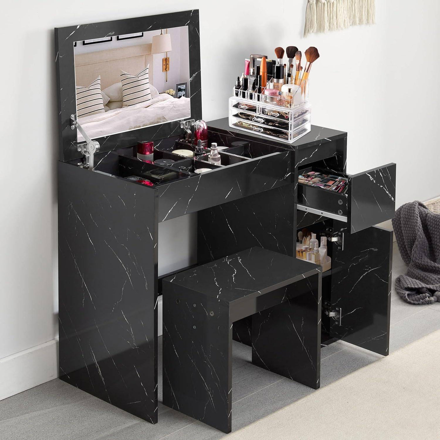 Small dressing table with flip-up mirror and stool in black marble finish, featuring multiple storage compartments for makeup and beauty accessories.