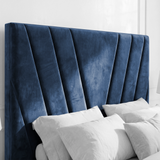 Side angle view of the velvet blue ottoman bed frame headboard, emphasizing its plush and stylish design