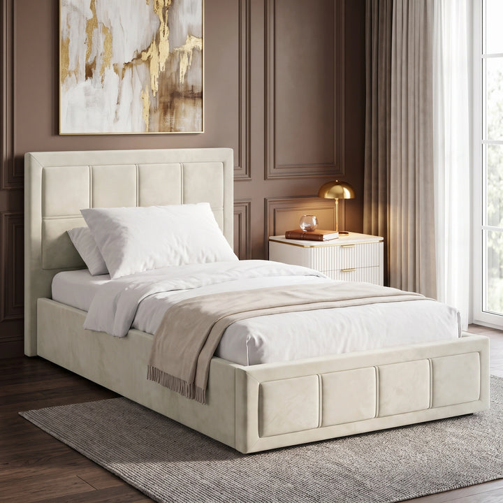 [Single | Beige] upholstered bed frame with a padded headboard and matching footboard, shown in a styled bedroom setting with white bedding, a beige throw blanket, a nightstand, and a window.