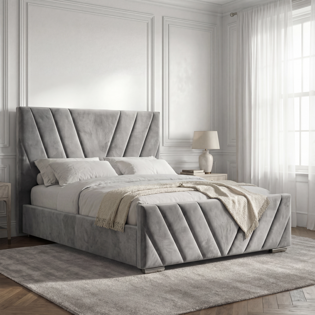 Side angle view of the velvet king-size grey ottoman bed frame, showcasing its stylish design and soft curves