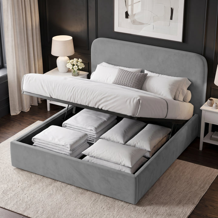 [Light Grey | King] upholstered bed frame with the headboard raised, showing a white bedding set and folded linens