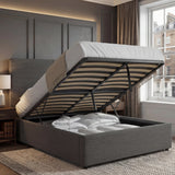 [Double | Grey] Velvet ottoman bed base tilted up, double size, storage compartment full of bedding against panelling