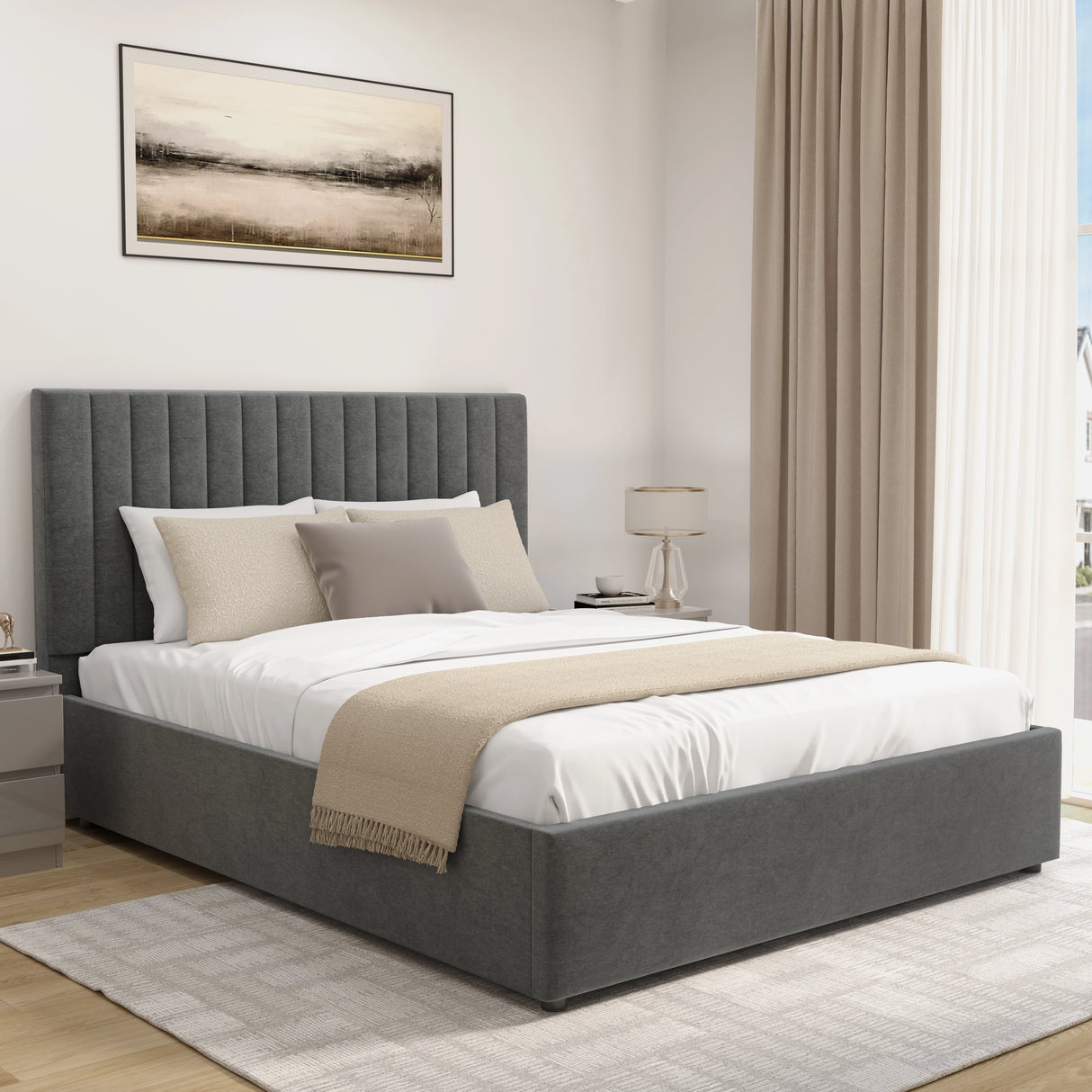 Gray upholstered bed with white bedding and beige blanket in a bedroom setting.
