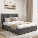 Gray upholstered bed with white bedding and beige blanket in a bedroom setting.