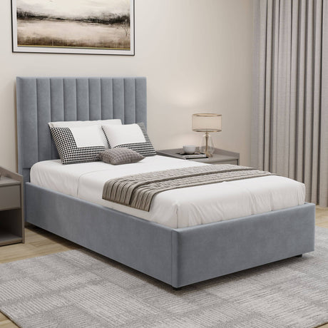 Grey velvet single ottoman bed frame with vertical panel headboard & storage, styled with bedding in a cozy modern bedroom.