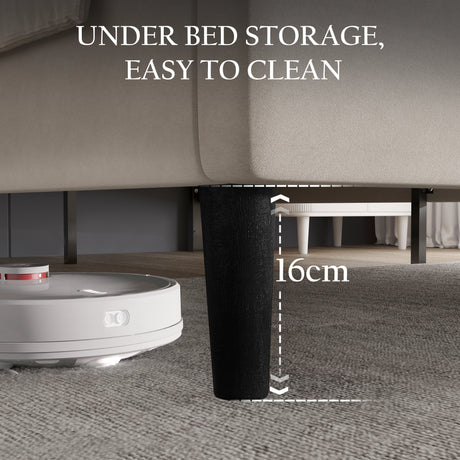 [King | Beige] Low-angle showing space underneath velvet bed frame with tapered dark legs for vacuum access