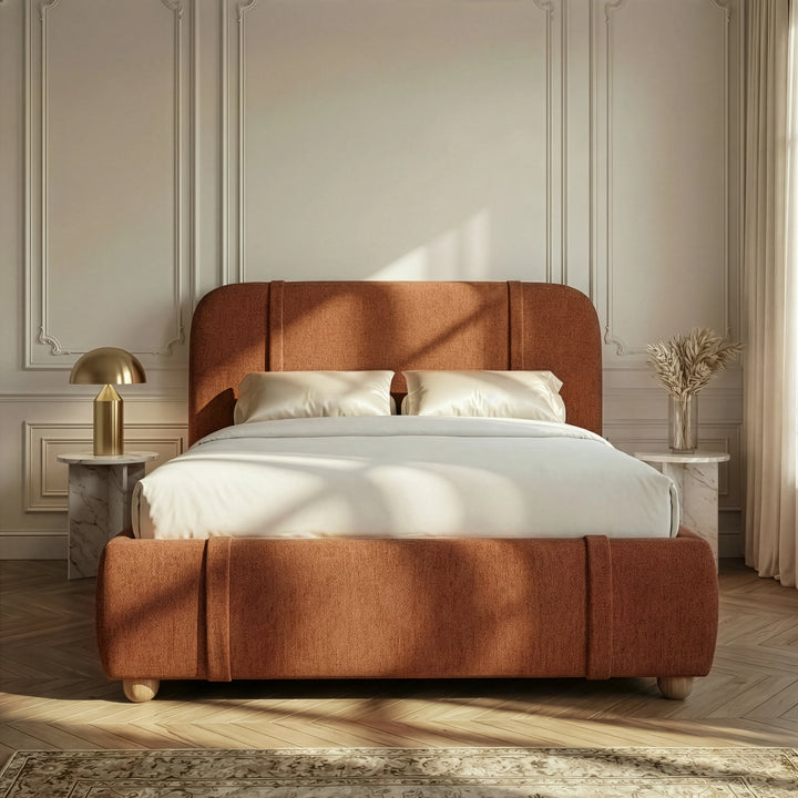 [Double | Orange] Fabric bed from the front with white satin bedding and brass dome lamp on marble table