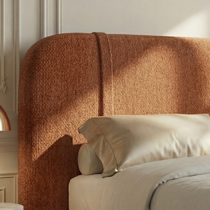 [King | Orange] Close-up of curved headboard showing rich chenille texture with vertical channel stitch in sunlight