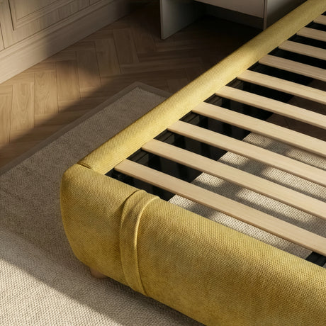 [King | Yellow] Bed frame base showing wooden slats and rounded padded footboard corner from above