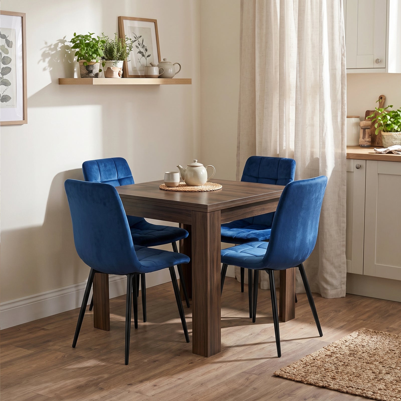 [Walnut] Folded flip-top extendable dining table with four blue chairs and tea set in a bright open-plan kitchen diner.