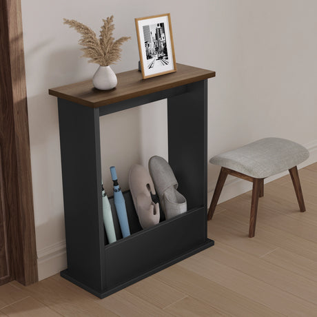 Black shoe rack with shoes, a vase, and a framed picture on a gray surface in a room.
