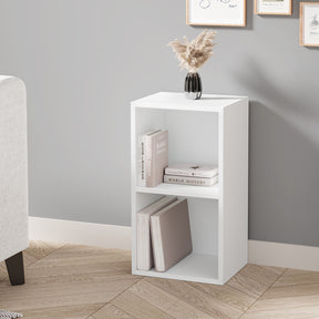 angled front view of white 2 shelf bookcase styled with decor and books, great for small corners in modern living spaces