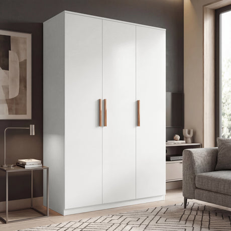 Three door plain white wardrobe in room setting with wooden handles and doors closed placed in a natural light